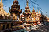 Vientiane, Laos - Pha That Luang, Other structures on the ground include a bell tower, several stupas, a number of pavilions sheltering images of the Buddha. 
